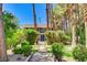 Charming home exterior featuring a bridge to the entryway and lush green landscaping at 5260 N Jones Blvd, Las Vegas, NV 89130