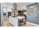 Modern kitchen with marble counters, wooden floors, and stainless steel appliances at 5260 N Jones Blvd, Las Vegas, NV 89130
