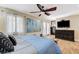A comfortable main bedroom features a ceiling fan, large dresser, and mounted television at 5260 N Jones Blvd, Las Vegas, NV 89130