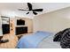 The main bedroom features a mounted television, dresser, and ceiling fan at 5260 N Jones Blvd, Las Vegas, NV 89130