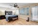 A spacious main bedroom features a ceiling fan, bench, and light wood flooring at 5260 N Jones Blvd, Las Vegas, NV 89130