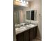 Modern bathroom with double vanity sinks, and a well lit mirror at 5363 S Juneau St, Pahrump, NV 89061