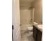 This bathroom features a shower over bath, dark wood vanity and grey tile floor at 5363 S Juneau St, Pahrump, NV 89061
