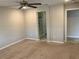 A neutral bedroom featuring a ceiling fan and entrances to both a bathroom and closet at 5363 S Juneau St, Pahrump, NV 89061