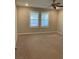 A bedroom with two windows with modern white shutters and a ceiling fan at 5363 S Juneau St, Pahrump, NV 89061