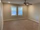 A bedroom with two windows with modern white shutters and a ceiling fan at 5363 S Juneau St, Pahrump, NV 89061