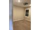 This bedroom includes neutral carpeting, a modern ceiling fan and bright natural light from the window at 5363 S Juneau St, Pahrump, NV 89061