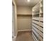 Organized walk-in closet with built-in shelving and drawer system with a hanging rod at 5363 S Juneau St, Pahrump, NV 89061