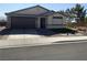 Single-story home featuring a two-car garage, desert landscaping, and a neutral color palette at 5363 S Juneau St, Pahrump, NV 89061