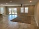 Open living room featuring tile floors, a ceiling fan, recessed lights, and a sliding glass door at 5363 S Juneau St, Pahrump, NV 89061