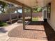 A covered patio includes a stone firepit and a manicured lawn, for relaxation or entertainment at 5363 S Juneau St, Pahrump, NV 89061