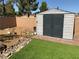 The backyard shed offers additional storage space and is surrounded by lush greenery at 5363 S Juneau St, Pahrump, NV 89061