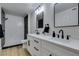 A modern bathroom featuring a double sink vanity, black hardware, and a walk-in shower with black and white tile at 555 E Silverado Ranch Blvd # 2129, Las Vegas, NV 89183