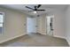 Open bedroom view showcasing gray carpet, neutral walls, and access to bathroom and closet at 555 E Silverado Ranch Blvd # 2129, Las Vegas, NV 89183
