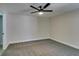 A spacious bedroom with gray carpet, a ceiling fan, and neutral-colored walls at 555 E Silverado Ranch Blvd # 2129, Las Vegas, NV 89183