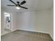 Comfortable bedroom features neutral walls, ceiling fan, gray carpet, and access to a bathroom at 555 E Silverado Ranch Blvd # 2129, Las Vegas, NV 89183