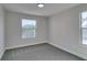 Well-lit bedroom with gray carpet, neutral walls, and two windows providing ample natural light at 555 E Silverado Ranch Blvd # 2129, Las Vegas, NV 89183