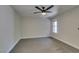 Modern bedroom with neutral walls, gray carpet, a ceiling fan, and a window for natural light at 555 E Silverado Ranch Blvd # 2129, Las Vegas, NV 89183