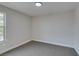 A bright bedroom featuring neutral-colored walls, gray carpet, and a window letting in natural light at 555 E Silverado Ranch Blvd # 2129, Las Vegas, NV 89183