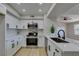 Contemporary kitchen with white cabinetry, stainless steel appliances, and a stylish black faucet at 555 E Silverado Ranch Blvd # 2129, Las Vegas, NV 89183