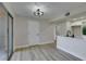 Open-concept living area with sliding glass doors and wood-look flooring at 555 E Silverado Ranch Blvd # 2129, Las Vegas, NV 89183