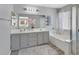 Large bathroom with a double vanity, a separate shower, and a large soaking tub at 5923 Halehaven Dr, Las Vegas, NV 89110