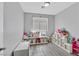 Cozy bedroom featuring gray laminate floors, bright lighting, and organized shelving at 5923 Halehaven Dr, Las Vegas, NV 89110