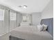 Bedroom featuring a plush gray bed with matching headboard and neutral walls at 5923 Halehaven Dr, Las Vegas, NV 89110