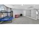 Spacious upper level bonus room with gray carpet, furniture, and natural light from a large window at 5923 Halehaven Dr, Las Vegas, NV 89110