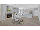 Dining area with fireplace open to the kitchen with stainless appliances at 5923 Halehaven Dr, Las Vegas, NV 89110