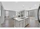 Open kitchen with center island flowing into the adjacent dining area at 5923 Halehaven Dr, Las Vegas, NV 89110