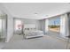 Primary bedroom boasts soft gray carpet, large windows, and an ensuite bath at 5923 Halehaven Dr, Las Vegas, NV 89110