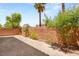 Paver patio in the backyard of a residence showcasing desert landscaping, greenery and privacy wall at 6014 Belvedere Canyon Ave, Las Vegas, NV 89139