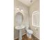 Small half bathroom features a pedestal sink, toilet, and neutral colors at 6014 Belvedere Canyon Ave, Las Vegas, NV 89139