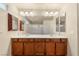 Well lit bathroom showcasing double sinks, granite countertops and contemporary fixtures at 6014 Belvedere Canyon Ave, Las Vegas, NV 89139