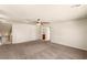 Cozy bedroom featuring neutral paint, plush carpeting, and a ceiling fan with adjacent access to the bathroom at 6014 Belvedere Canyon Ave, Las Vegas, NV 89139