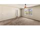 A spacious bedroom features carpet flooring, a ceiling fan, and light-colored walls at 6014 Belvedere Canyon Ave, Las Vegas, NV 89139