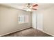 This bedroom offers neutral paint, carpet, ceiling fan and a window with natural light at 6014 Belvedere Canyon Ave, Las Vegas, NV 89139