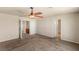 A spacious bedroom has a ceiling fan, carpet flooring, and light walls at 6014 Belvedere Canyon Ave, Las Vegas, NV 89139
