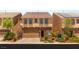 Charming two-story home boasts a stone facade and manicured landscaping at 6014 Belvedere Canyon Ave, Las Vegas, NV 89139