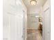 Hallway leading to bathroom with white doors and tile flooring at 6014 Belvedere Canyon Ave, Las Vegas, NV 89139
