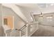 Staircase landing with glass railing, neutral paint, carpet, and windows at 6014 Belvedere Canyon Ave, Las Vegas, NV 89139