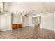 An open-plan living room with light walls, tiled floors, and a ceiling fan at 6014 Belvedere Canyon Ave, Las Vegas, NV 89139