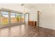 An open living room with large windows, light walls, tiled floors, and a ceiling fan at 6014 Belvedere Canyon Ave, Las Vegas, NV 89139