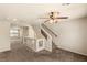 This open living room features neutral paint, carpet and staircase at 6014 Belvedere Canyon Ave, Las Vegas, NV 89139
