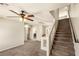 This staircase is carpeted and has white painted bannister and brown handrail at 6014 Belvedere Canyon Ave, Las Vegas, NV 89139