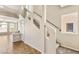 A view of the carpeted staircase with white risers, black handrail and landing at 6014 Belvedere Canyon Ave, Las Vegas, NV 89139