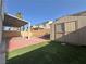 This backyard includes a storage shed, a covered patio, and artificial turf for a low-maintenance outdoor space at 6063 Peach Orchard Rd, Las Vegas, NV 89142