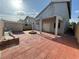 Large backyard with covered patio, brick fire pit, plus a storage shed; ideal for relaxing and outdoor activities at 6063 Peach Orchard Rd, Las Vegas, NV 89142