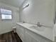 Bright bathroom featuring a double vanity with white cabinetry, modern fixtures, and white countertop at 6063 Peach Orchard Rd, Las Vegas, NV 89142